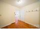 Entryway features wood floors, hall tree, and a view into the light and bright kitchen at 8222 Henry Harris Rd, Fort Mill, SC 29707