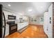Bright kitchen featuring white cabinets, stainless steel appliances, hardwood floors and an open layout at 8222 Henry Harris Rd, Fort Mill, SC 29707