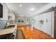 Bright kitchen featuring white cabinets, stainless steel appliances, hardwood floors and an open layout at 8222 Henry Harris Rd, Fort Mill, SC 29707