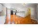 Modern kitchen with white cabinets, hardwood floors, and stainless steel appliances at 8222 Henry Harris Rd, Fort Mill, SC 29707