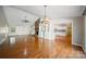 Open-concept living room with hardwood floors, brick fireplace, and built-in bookshelves at 8222 Henry Harris Rd, Fort Mill, SC 29707