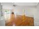 Open living room with hardwood floors, a fireplace, built-in storage, and sliding doors to the backyard at 8222 Henry Harris Rd, Fort Mill, SC 29707