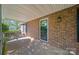 The brick-paved covered porch offers a shady spot by the front door with ample room for seating at 8222 Henry Harris Rd, Fort Mill, SC 29707