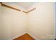 Empty room with neutral walls, hardwood floors, trim and base molding, ready for customization at 8222 Henry Harris Rd, Fort Mill, SC 29707