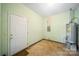 Functional utility room with a water heater and access door, perfect for storage and maintenance needs at 8222 Henry Harris Rd, Fort Mill, SC 29707