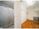 Walk-in closet and shower include white walls, hardwood floors, wire shelving, and a shower with a curtain at 8222 Henry Harris Rd, Fort Mill, SC 29707