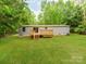 Spacious backyard featuring a deck, green grass, and mature trees, offering privacy at 850 Deep Hollow Ct, Clover, SC 29710