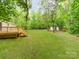 Wooded backyard with large lawn, deck, and storage shed at 850 Deep Hollow Ct, Clover, SC 29710