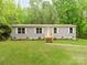 Charming single-story home featuring a well-maintained lawn and a welcoming front porch with wooden stairs at 850 Deep Hollow Ct, Clover, SC 29710