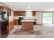 Open kitchen with dark appliances, island with marble countertop, wood cabinets, and hardwood floors at 850 Deep Hollow Ct, Clover, SC 29710