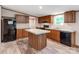 Spacious kitchen features wooden cabinets, stainless steel appliances, a kitchen island, and modern wood-look floors at 850 Deep Hollow Ct, Clover, SC 29710