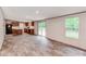 Open-concept living area with wood-look floors, sliding glass door to deck, and kitchen visible in background at 850 Deep Hollow Ct, Clover, SC 29710