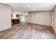 Open concept living room and kitchen. Features hardwood floors and light walls throughout the space at 850 Deep Hollow Ct, Clover, SC 29710