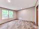 Bright living room featuring wood-look flooring and ample natural light from two large windows at 850 Deep Hollow Ct, Clover, SC 29710