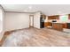 Open concept living room next to kitchen with laminate wood floors and stainless steel appliances at 850 Deep Hollow Ct, Clover, SC 29710
