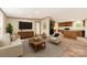 Bright living room featuring a cozy seating area, TV, and seamless flow into the kitchen at 850 Deep Hollow Ct, Clover, SC 29710