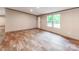 Bright living room with wood-look flooring and natural light, next to front door with windows to the side at 850 Deep Hollow Ct, Clover, SC 29710