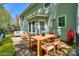 Back deck featuring outdoor seating, a dining table, and lush plant decor at 8709 Stratton Farm Rd, Huntersville, NC 28078