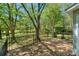 A spacious backyard featuring a deck, beautiful landscaping, and verdant lawn at 8709 Stratton Farm Rd, Huntersville, NC 28078