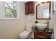 Charming half bathroom featuring decorative vanity with vessel sink and window providing natural light at 8709 Stratton Farm Rd, Huntersville, NC 28078