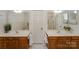 Bright bathroom features double vanity with white countertops and wood cabinets, plus mirrors at 8709 Stratton Farm Rd, Huntersville, NC 28078