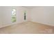 Neutral bedroom with large windows offering natural light and plush carpet flooring at 8709 Stratton Farm Rd, Huntersville, NC 28078