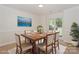 Elegant dining room featuring a wooden table with seating for six and a large window at 8709 Stratton Farm Rd, Huntersville, NC 28078
