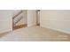 Open hallway with staircase featuring hardwood floors and white trim, connecting different areas at 8709 Stratton Farm Rd, Huntersville, NC 28078