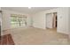 Spacious living room with natural light, carpet, an exterior door, and a view of the outdoors at 8709 Stratton Farm Rd, Huntersville, NC 28078