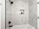 Bathroom featuring white marble tile shower and brushed black shower hardware at 910 Lightwood Dr, Matthews, NC 28105