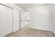 Bedroom featuring a large closet, access to another room, and neutral carpet at 910 Lightwood Dr, Matthews, NC 28105