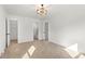 Bedroom featuring a modern light fixture, neutral carpet, and ensuite bathroom and closet at 910 Lightwood Dr, Matthews, NC 28105