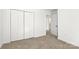 Bedroom featuring a large closet with white doors and neutral carpet at 910 Lightwood Dr, Matthews, NC 28105