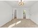 Spacious bedroom featuring neutral carpet, a modern light fixture, and ensuite bathroom and closet at 910 Lightwood Dr, Matthews, NC 28105