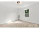 Light-filled bedroom with a neutral color scheme, a large window, and soft carpet at 910 Lightwood Dr, Matthews, NC 28105