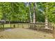 Expansive wooden deck, perfect for outdoor entertaining, overlooks the private, tree-filled backyard at 910 Lightwood Dr, Matthews, NC 28105