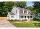 Charming two-story home with light blue siding, black shutters, and a welcoming front porch at 910 Lightwood Dr, Matthews, NC 28105