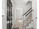 Bright foyer with staircase and luxury vinyl plank floors at 910 Lightwood Dr, Matthews, NC 28105