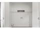 White laundry room features wire shelving, washer/dryer hookups, and an electrical outlet at 910 Lightwood Dr, Matthews, NC 28105