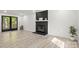Inviting living room with a cozy fireplace, modern flooring, and French doors to the backyard at 910 Lightwood Dr, Matthews, NC 28105