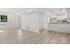 Open-concept living space with modern floors, fresh paint, and bar seating looking into kitchen at 910 Lightwood Dr, Matthews, NC 28105