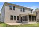 Home features a patio and sunroom in its backyard, along with horizontal siding and dark trim at 9849 Steele Meadow Rd, Charlotte, NC 28273