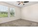 Bedroom with carpet, windows, and ceiling fan provides a bright and comfortable space at 9849 Steele Meadow Rd, Charlotte, NC 28273