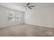 Bedroom with neutral carpet, bright windows and a ceiling fan at 9849 Steele Meadow Rd, Charlotte, NC 28273