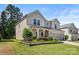 Beautiful two-story home with landscaped yard and charming architectural details at 9849 Steele Meadow Rd, Charlotte, NC 28273
