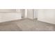 Spacious hallway with neutral walls and carpeting, bright natural light and many doorways at 9849 Steele Meadow Rd, Charlotte, NC 28273