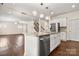 Open-concept kitchen with stainless steel appliances and a large granite island at 9849 Steele Meadow Rd, Charlotte, NC 28273