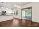 Modern kitchen with granite countertops that opens up to a dining space at 9849 Steele Meadow Rd, Charlotte, NC 28273