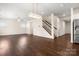 Spacious living area with hardwood floors and an open staircase at 9849 Steele Meadow Rd, Charlotte, NC 28273