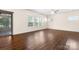 Expansive living room with hardwood floors, ceiling fan, and sliding glass door at 9849 Steele Meadow Rd, Charlotte, NC 28273